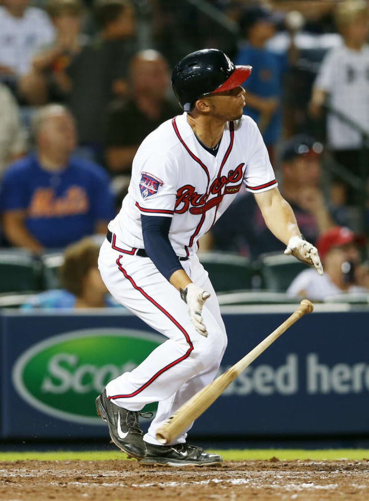 Atlanta Braves' Andrelton Simmons hits a ground ball in the eighth inning of a baseball game against the New York Mets in Atlanta, Monday, June 30, 2014. New York Mets third baseman Eric Campbell was charged with an error allowing the go-head run to score. Atlanta won 5-3. (AP Photo/John Bazemore)
