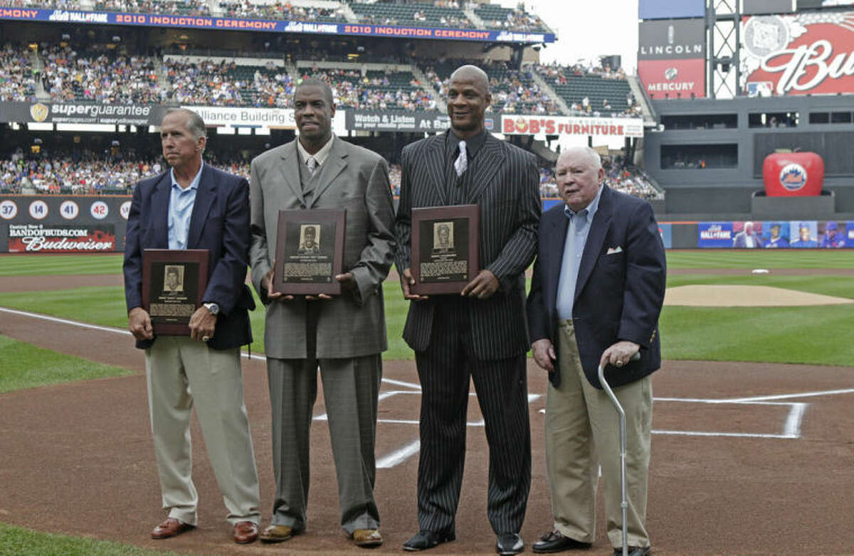 FILE - In this Aug. 1, 2010 file photo, from left, former New York Mets manager Davey Johnson, former Mets pitcher Dwight "Doc" Gooden, former Mets outfielder Darryl Strawberry, and former Mets general manager Frank Cashen pose after their induction into the Mets Hall of Fame before the Mets baseball game against the Arizona Diamondbacks at Citi Field in New York. The Mets say Cashen has died. He was 88. The team says Cashen died Monday, June 30, 2014, at a hospital in Easton, Maryland. (AP Photo/Kathy Willens, File)