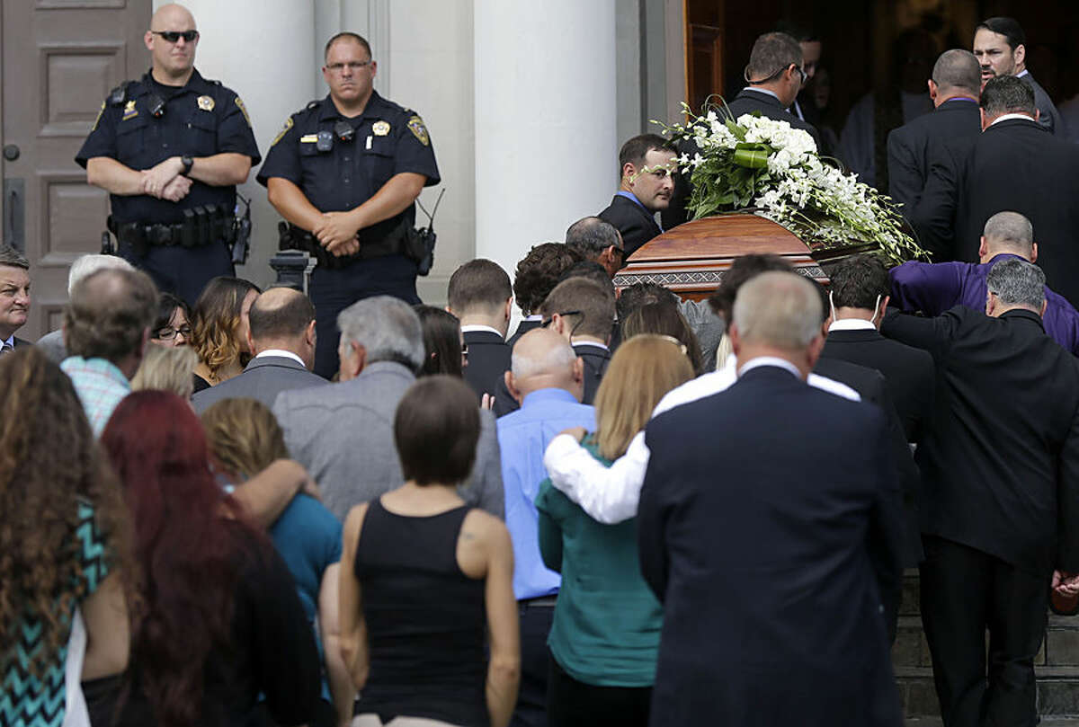 The casket of Mayci Breaux is carried into the Church of the Assumption, for her funeral in Franklin, La., Monday, July 27, 2015. Breaux was one of two people killed in Thursday's movie theater shooting in Lafayette, La. (AP Photo/Gerald Herbert)