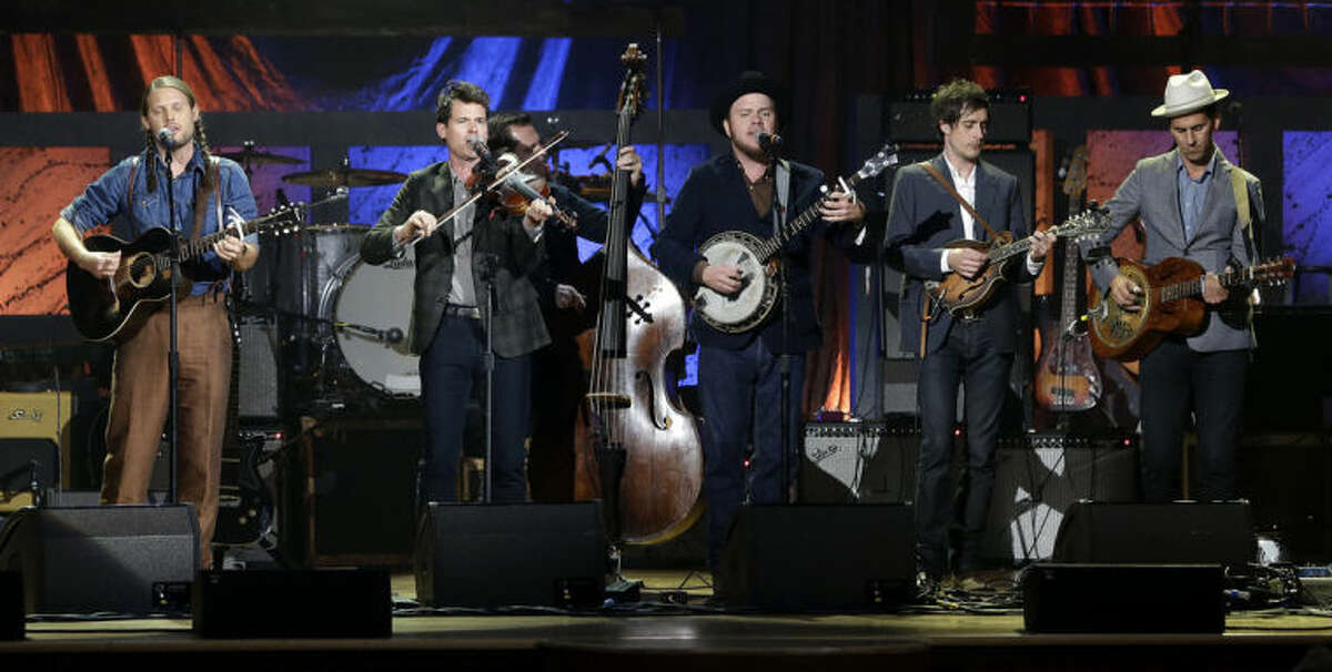 FILE - This Sept. 18, 2013 file photo shows, from left, Chance McCoy, Ketch Secor, Morgan Jahnig, Critter Fuqua, Cory Younts and Gill Landry from Old Crow Medicine Show performing during the Americana Music Honors and Awards Show in Nashville, Tenn. The band had their biggest hit of their career by adapting an unfinished Bob Dylan song into "Wagon Wheel," which became a staple in both Americana and country music. Ten years later, Dylan challenged them to finish another of his uncompleted songs for their new album, "Remedy." (AP Photo/Mark Humphrey, File)