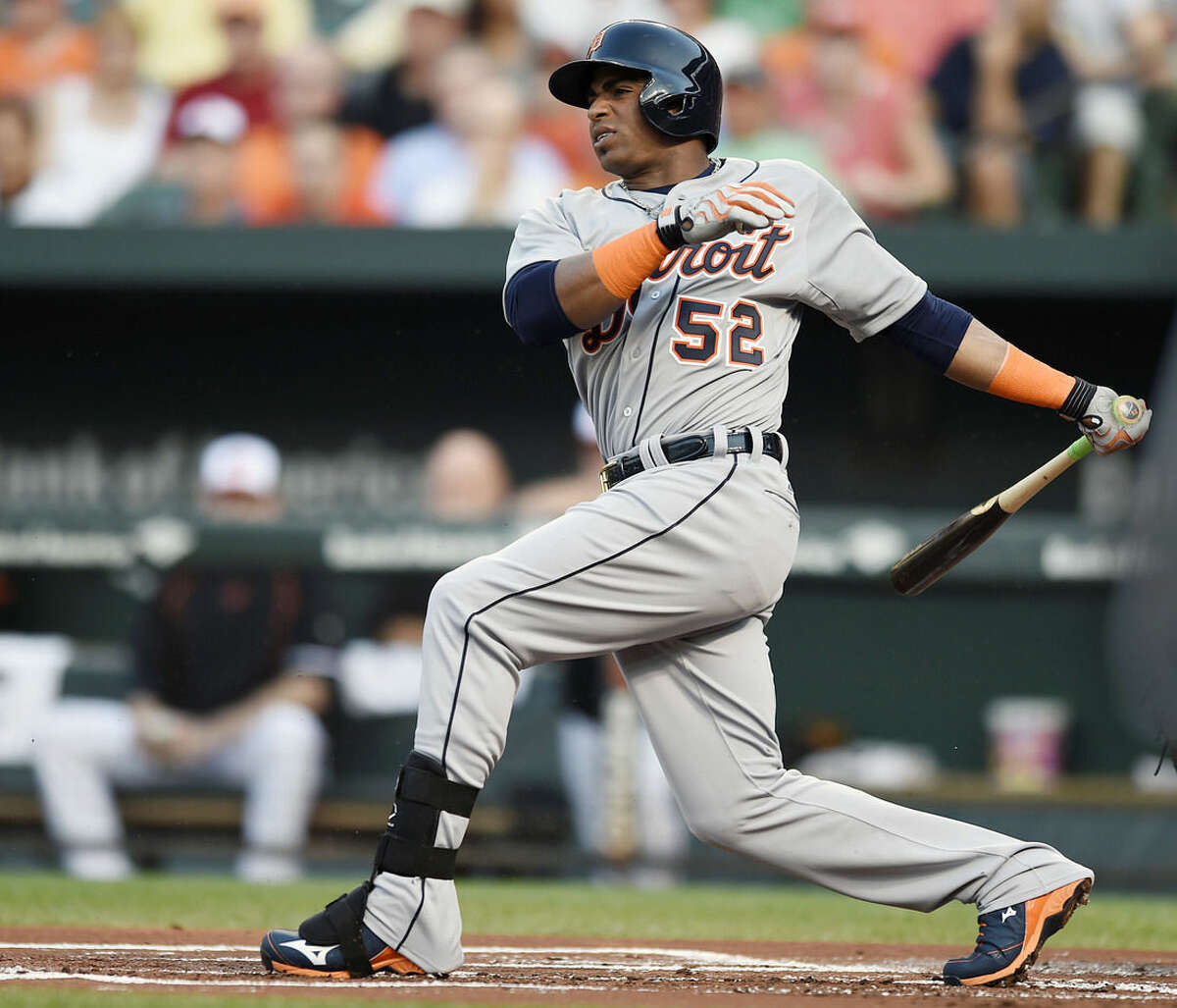 Detroit Tigers' Yoenis Cespedes follows through on a single against the Baltimore Orioles in the first inning of a baseball game, Thursday, July 30, 2015, in Baltimore.(AP Photo/Gail Burton)