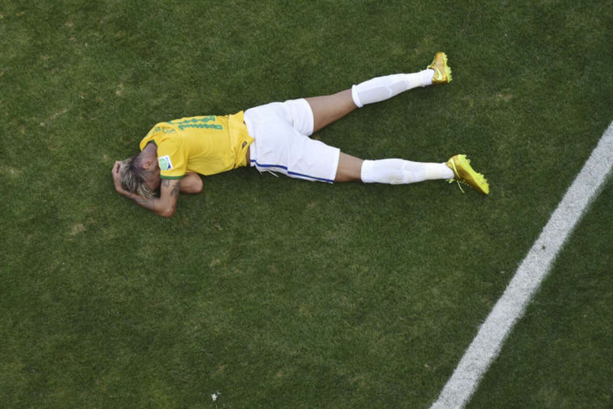 Brazil's Neymar sits on the pitch during the World Cup round of 16 soccer match between Brazil and Chile at the Mineirao Stadium in Belo Horizonte, Brazil, Saturday, June 28, 2014. (AP Photo/Francois Xavier Marit, pool)