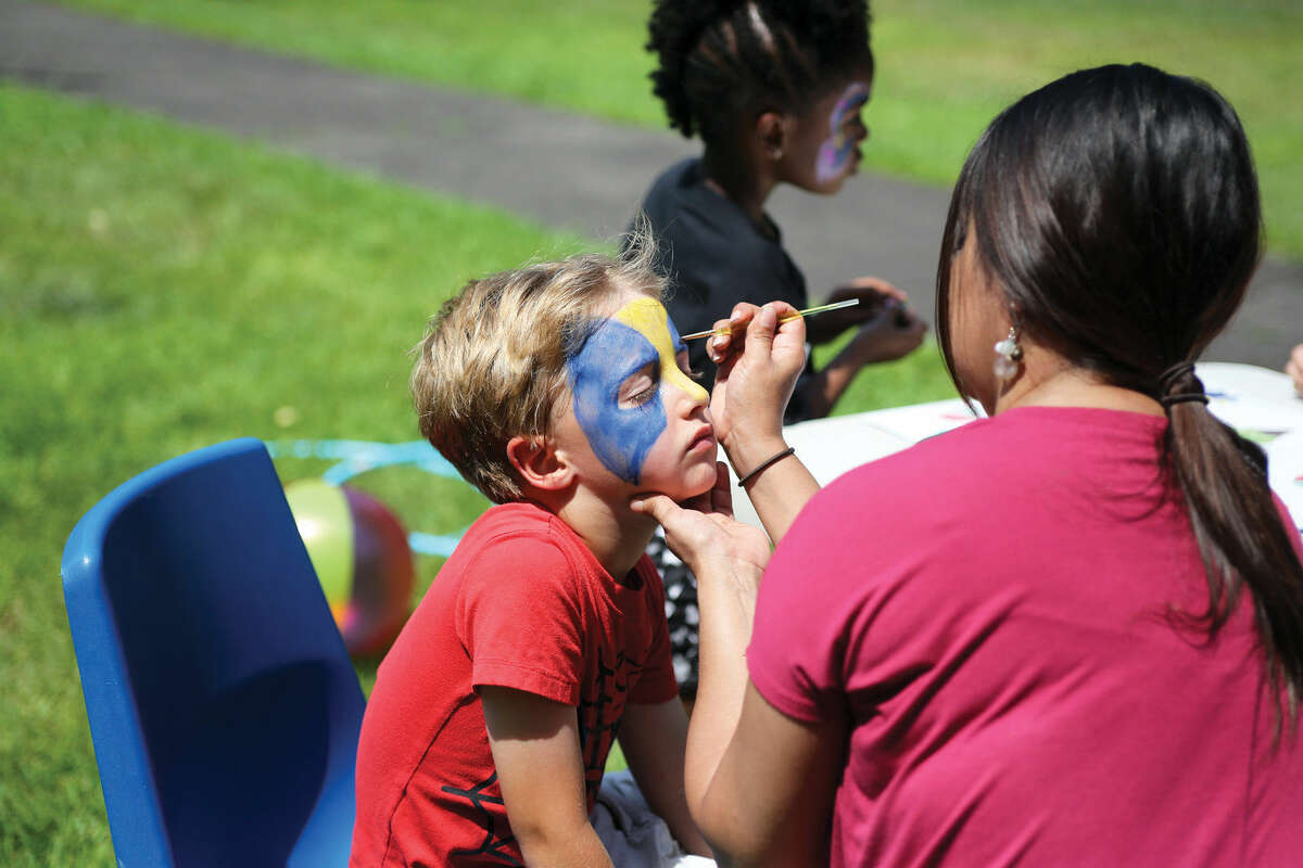 Westley Soreff, 6, gets his face painted during Norwalk’s Citywide Summer Reading Challenge-Family Fun Festival at Union Park in Norwalk Saturday morning. Hour Photo / Danielle Calloway