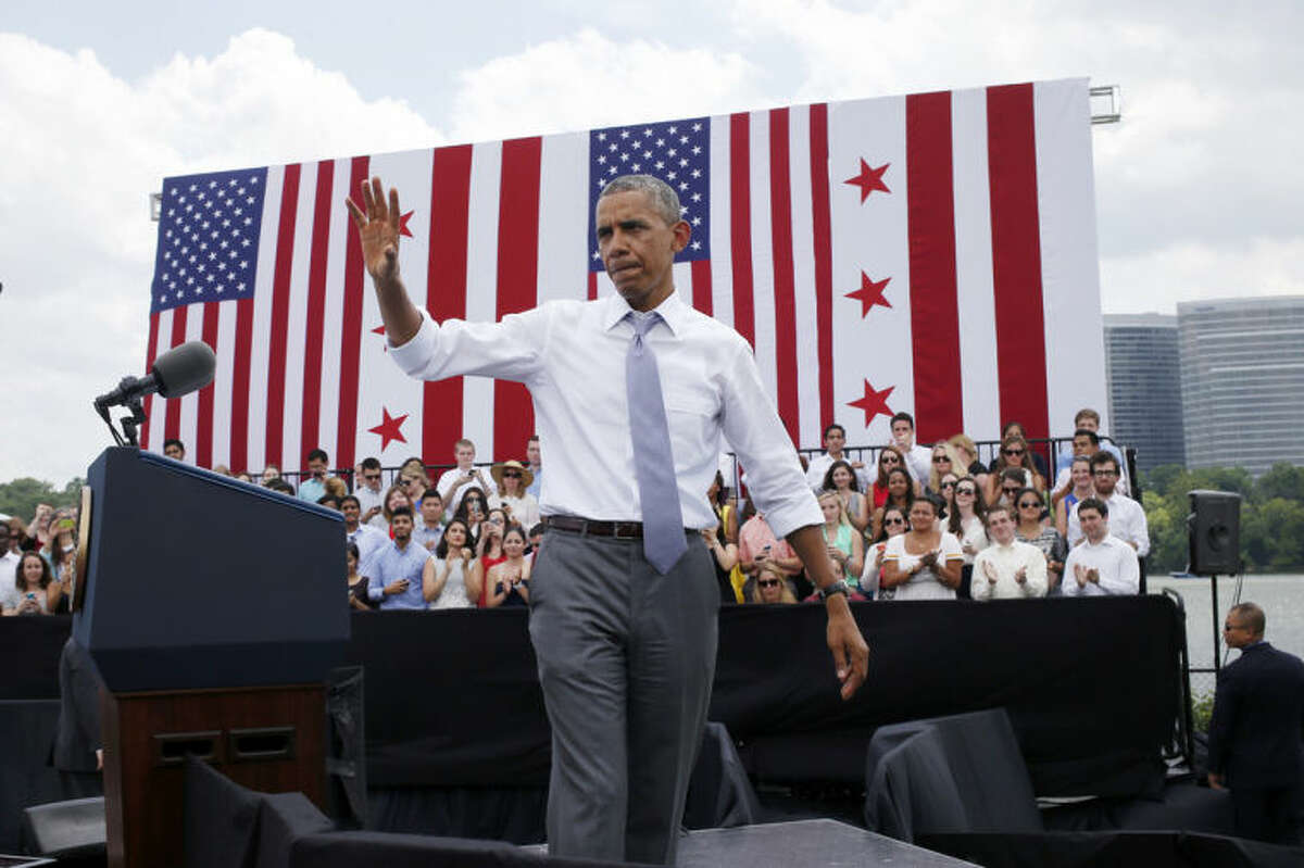 President Barack Obama waves after his remarks about transportation and the economy, Tuesday, July 1, 2014, at Georgetown Waterfront Park in Washington. The president said 700,000 jobs could be at risk next year if Congress doesn't quickly agree on how to pay for highway and transit programs. (AP Photo/Charles Dharapak)
