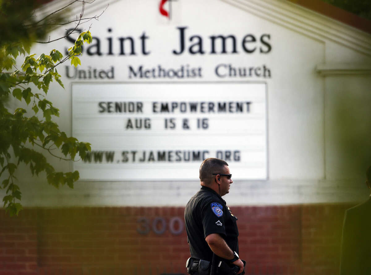 A police officer stands guard at the entrance to St. James United Methodist Church before funeral services for Bobbi Kristina Brown Saturday, Aug. 1, 2015, in Alpharetta, Ga. Brown, the only child of Whitney Houston and R&B singer Bobby Brown, died in hospice care July 26, about six months after she was found face-down and unresponsive in a bathtub in her suburban Atlanta townhome. (AP Photo/John Bazemore)