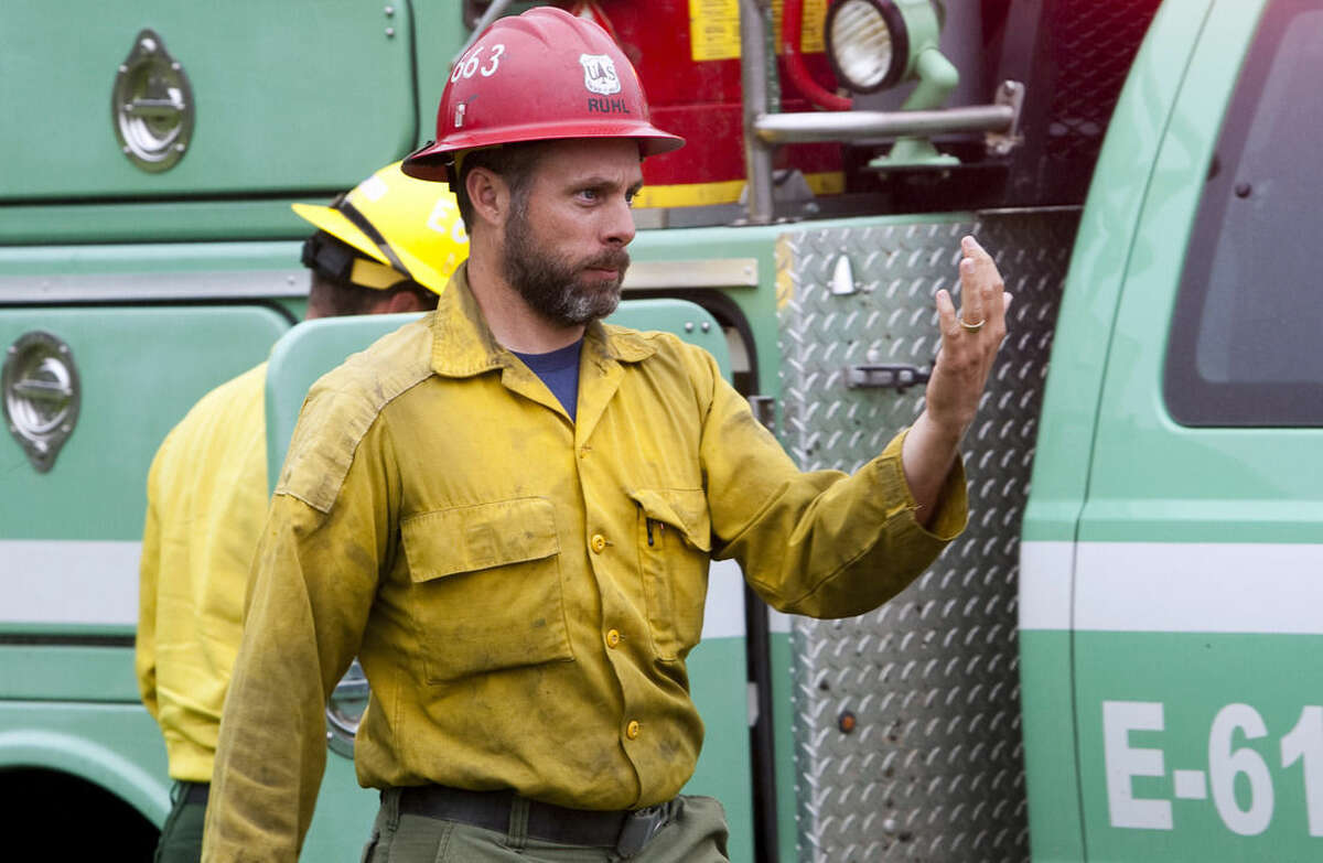 This 2014 photo provided by the Black Hills, S.D., National Forest shows U.S. Forest Service firefighter David Ruhl in the national forest near Custer, S.D. Ruhl, 38, of Rapid City, S.D., was killed while scouting a wildfire in Northern California when he became trapped by the wind-stoked blaze, officials said Saturday, Aug. 1, 2015. (Black Hills National Forest via AP)