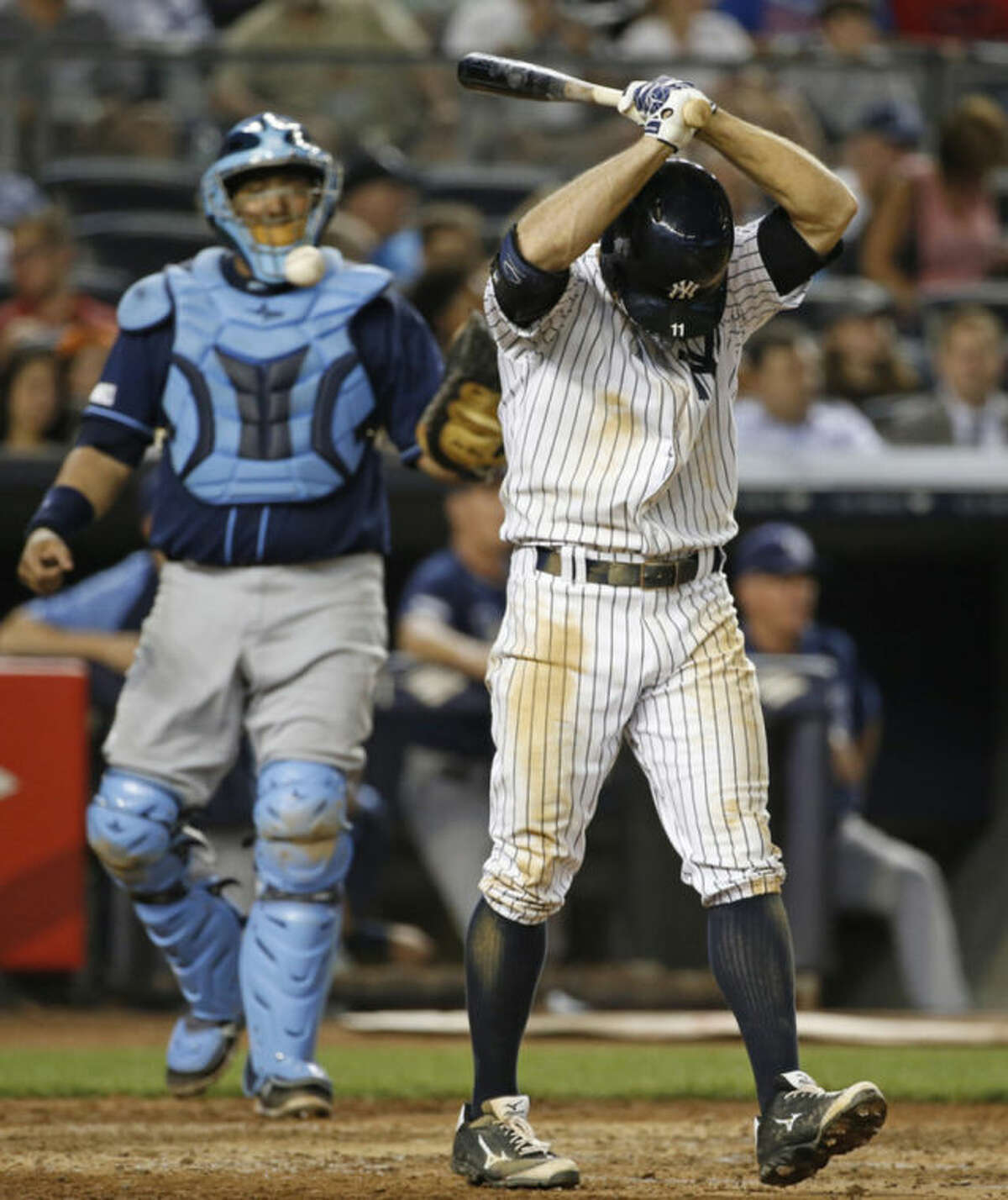 Tampa Bay Rays catcher Jose Molina, left, watches as New York Yankees Brett Gardner reacts after striking out with Yangervis Solarte at first base in a baseball game at Yankee Stadium in New York, Tuesday, July 1, 2014. (AP Photo/Kathy Willens)