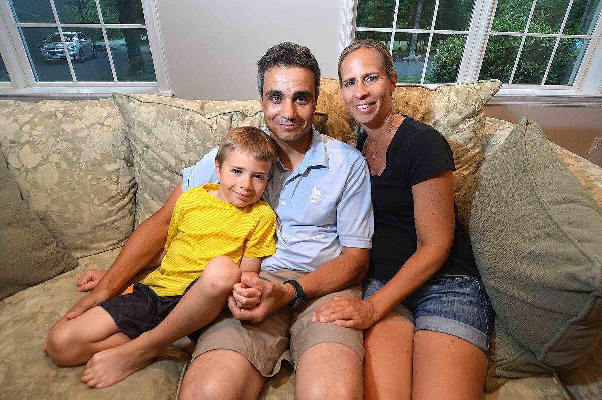 Mario and Andrea Ferrante sit for a photo with their 7-year-old son Christopher, who has undergone numerous surgeries for his scoliosis and kyphosis, and will soon undergo a new spinal lengthening treatment known as MAGEC.