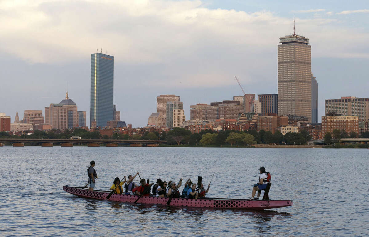 A boat glides along the Cambridge, Mass., side of the Charles River, Monday, July 27, 2105, in front of the Boston skyline, behind. The U.S. Olympic Committee officially severed ties with Boston on Monday, saying it was exploring other options amid lackluster public support and concerns from elected leaders and organized opposition about the impact to taxpayers. (AP Photo/Steven Senne)