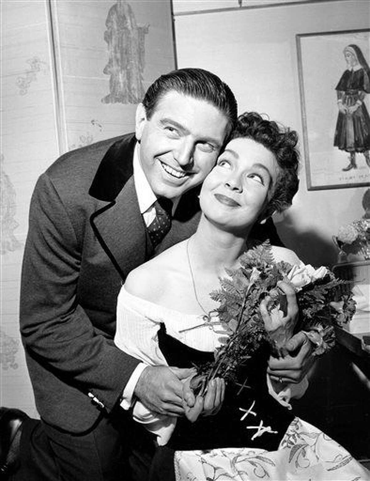 CORRECTS DATE OF DEATH TO TUESDAY, JULY 21 - FILE - In this May 12, 1960 file photo, Renee Guerin, of Juneau, Alaska, poses with her costar Theodore Bikel after their performance of "The Sound of Music" at the Lunt-Fontanne Theatre in New York City. Bikel, the Tony-nominated actor and singer whose passions included folk music and political activism, died Tuesday, July 21, 2015 in a Los Angeles hospital. He was 91. (AP Photo, File)