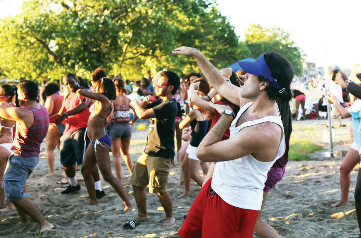 Steven Bravo does the "wobble" before Norwalk's annual firework display at Shady Beach Saturday evening. Hour Photo / Danielle Calloway
