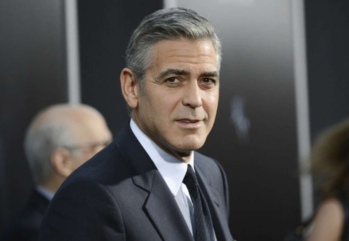 FILE - In this Oct. 1, 2013 file photo actor George Clooney attends the premiere of "Gravity" at the AMC Lincoln Square Theaters, in New York. George Clooney has chastised a British newspaper over an article claiming his fiancee's mother disapproves of the impending marriage for religious reasons. Clooney said that the claims about his future mother-in-law Baria Alamuddin were untrue and irresponsible. (Photo by Evan Agostini/Invision/AP, File)