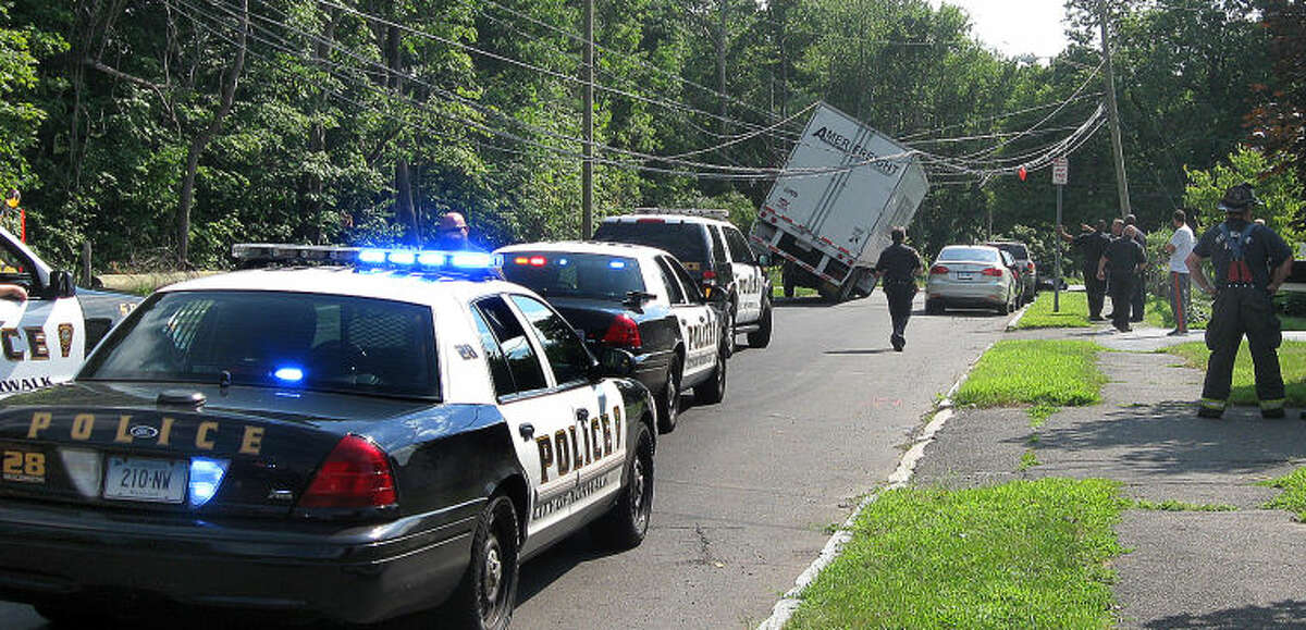 Hour photo / Chris Bosak A truck came to an abrupt and dangerous stop on Norden Place Friday morning after hitting wires. The road was closed.