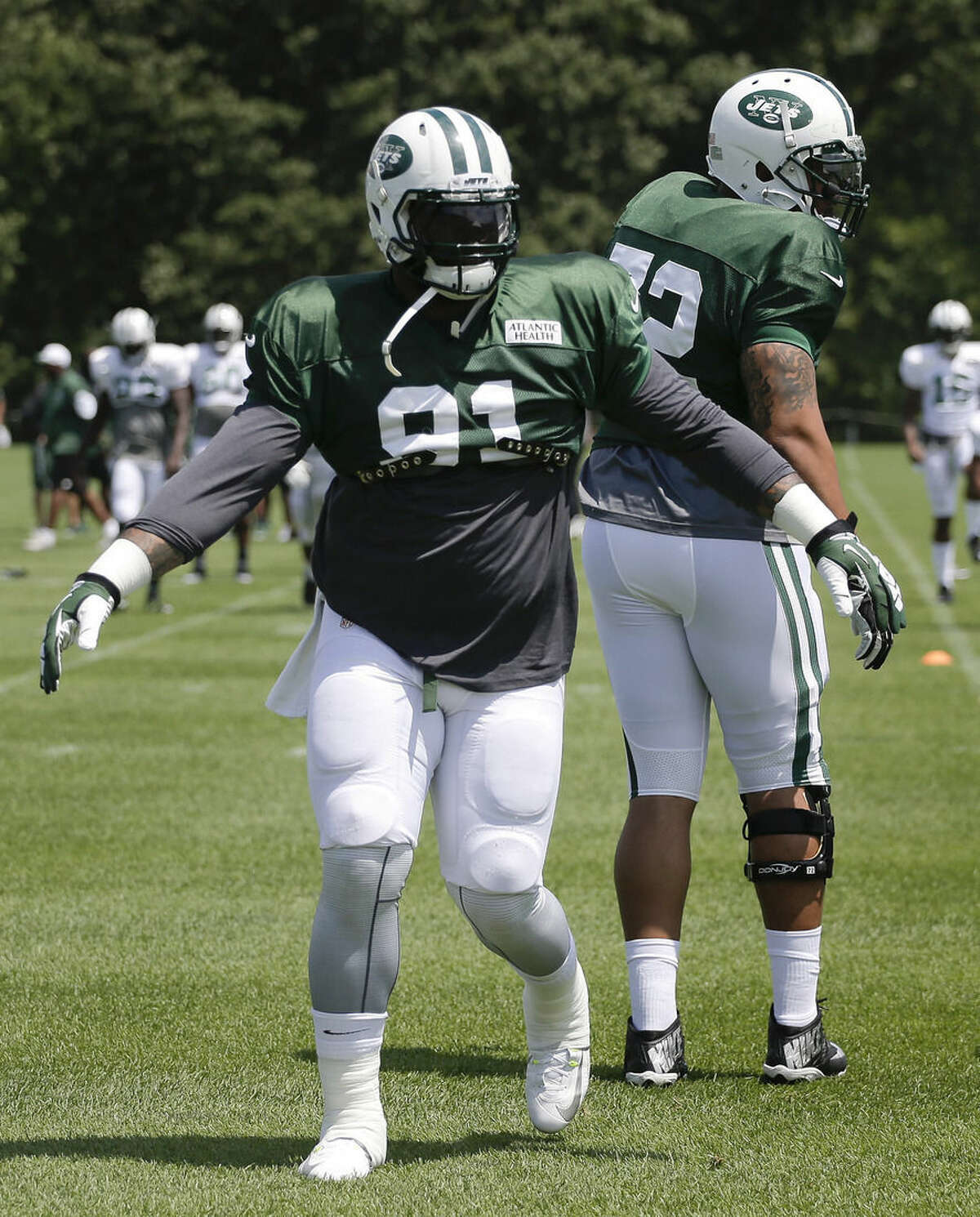 New York Jets defensive end Sheldon Richardson stretches with teammates at their NFL football training camp, Saturday, Aug. 1, 2015, in Florham Park, N.J. (AP Photo/Julie Jacobson)