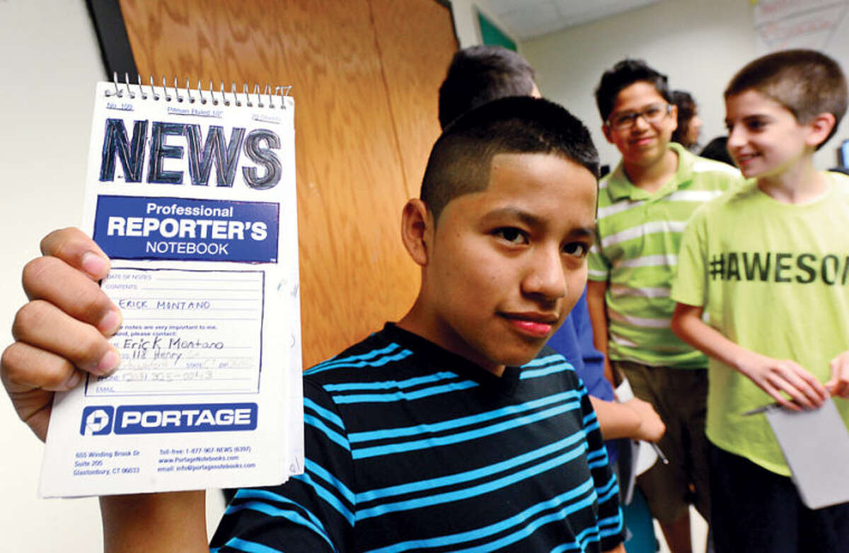Westhill alumni created Project Lede, a summer program that teaches journalism to middle school students, including 12-year-old Erick Montano, during a session at Toquam Magnet School Friday. The program also teaches the middle schoolers how to create a student newspaper.