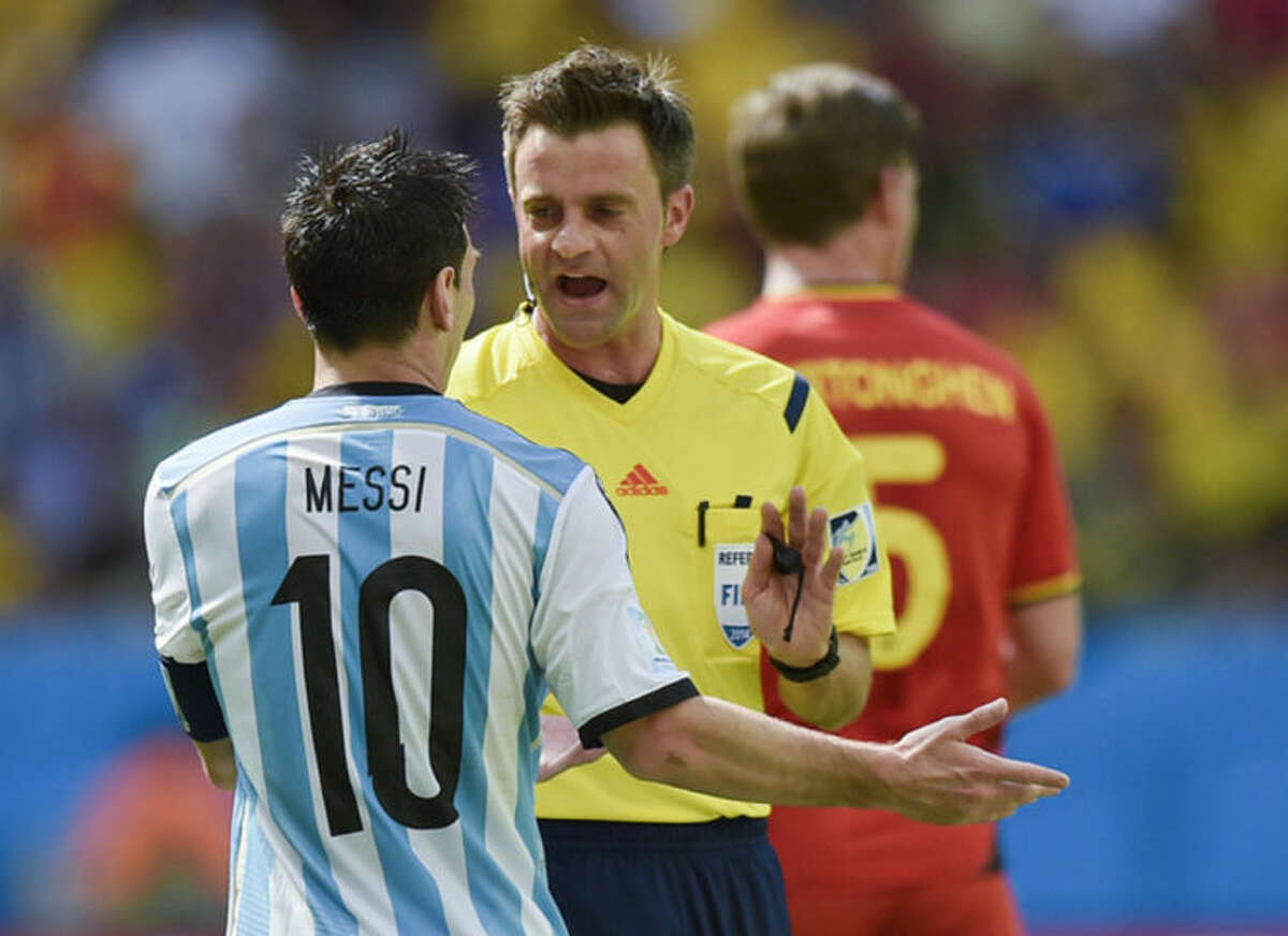 Referee Nicola Rizzoli of Italy speaks with Argentina's Lionel Messi during the World Cup quarterfinal soccer match between Argentina and Belgium at the Estadio Nacional in Brasilia, Brazil, Saturday, July 5, 2014. (AP Photo/Martin Meissner)