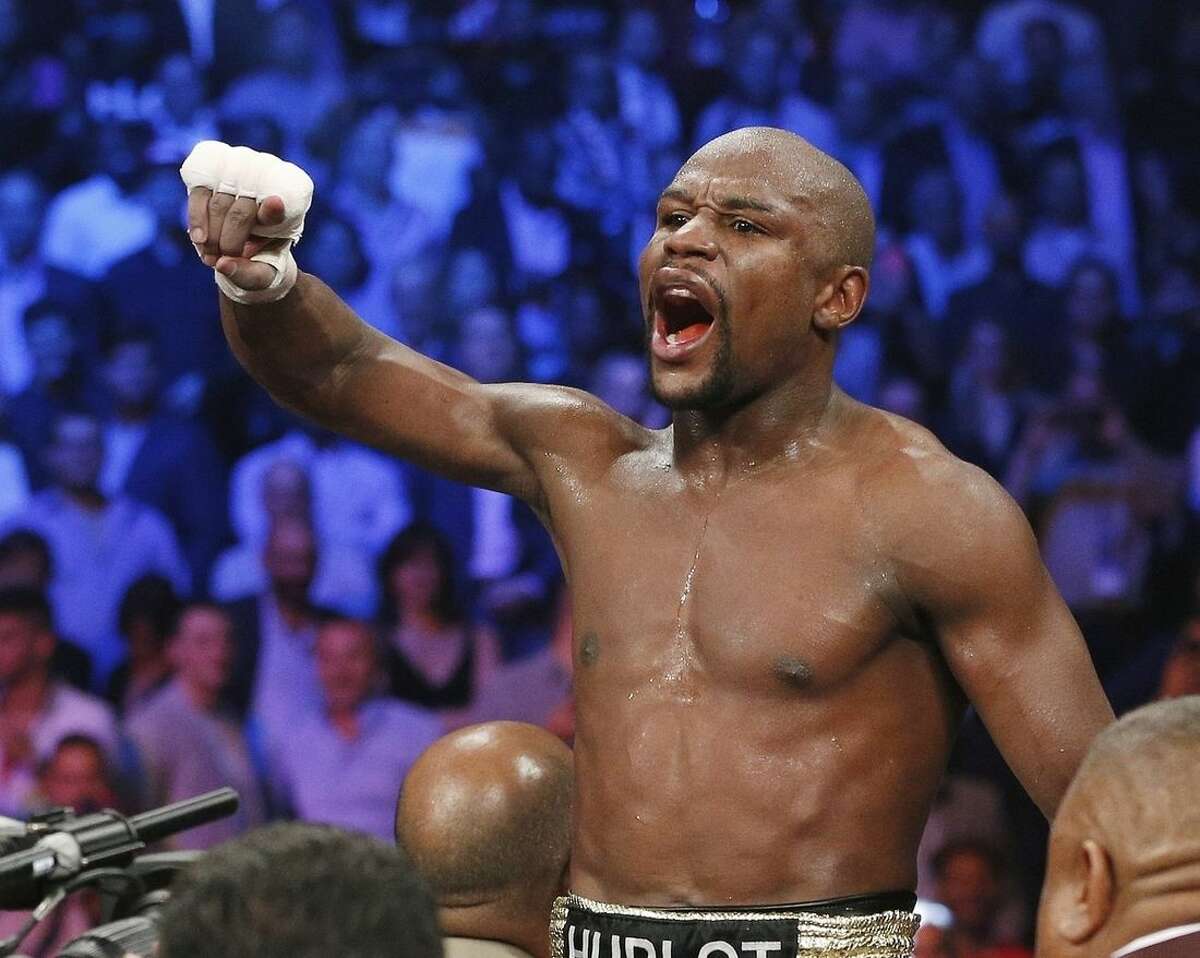 FILE - In this May 2, 2015, file photo, boxer Floyd Mayweather Jr., celebrates his unanimous decision victory over Manny Pacquiao, from the Philippines, after their welterweight title fight in Las Vegas. Mayweather Jr. will return to the ring for the first time since boxing's richest fight ever, facing Andre Berto on Sept. 12 in Las Vegas. (AP Photo/John Locher, File)