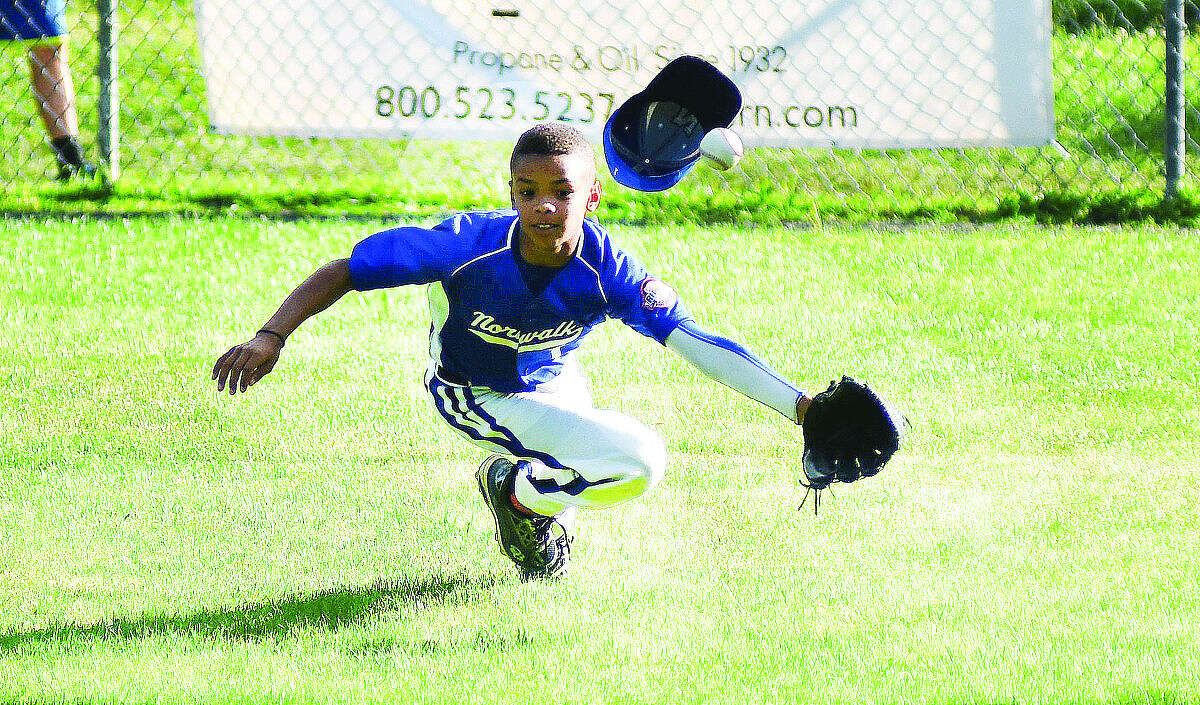 Hour photo/John Nash - Norwalk's AJ Robinson tries to come up with a spectacular diving catch during Wednesday's loser's bracket final between Norwalk and Swanzey, N.H., at the New England Regional 11-year-old Cal Ripken Tournament in Dover, N.H. Norwalk won, 4-3, to advance to the regional championship game.