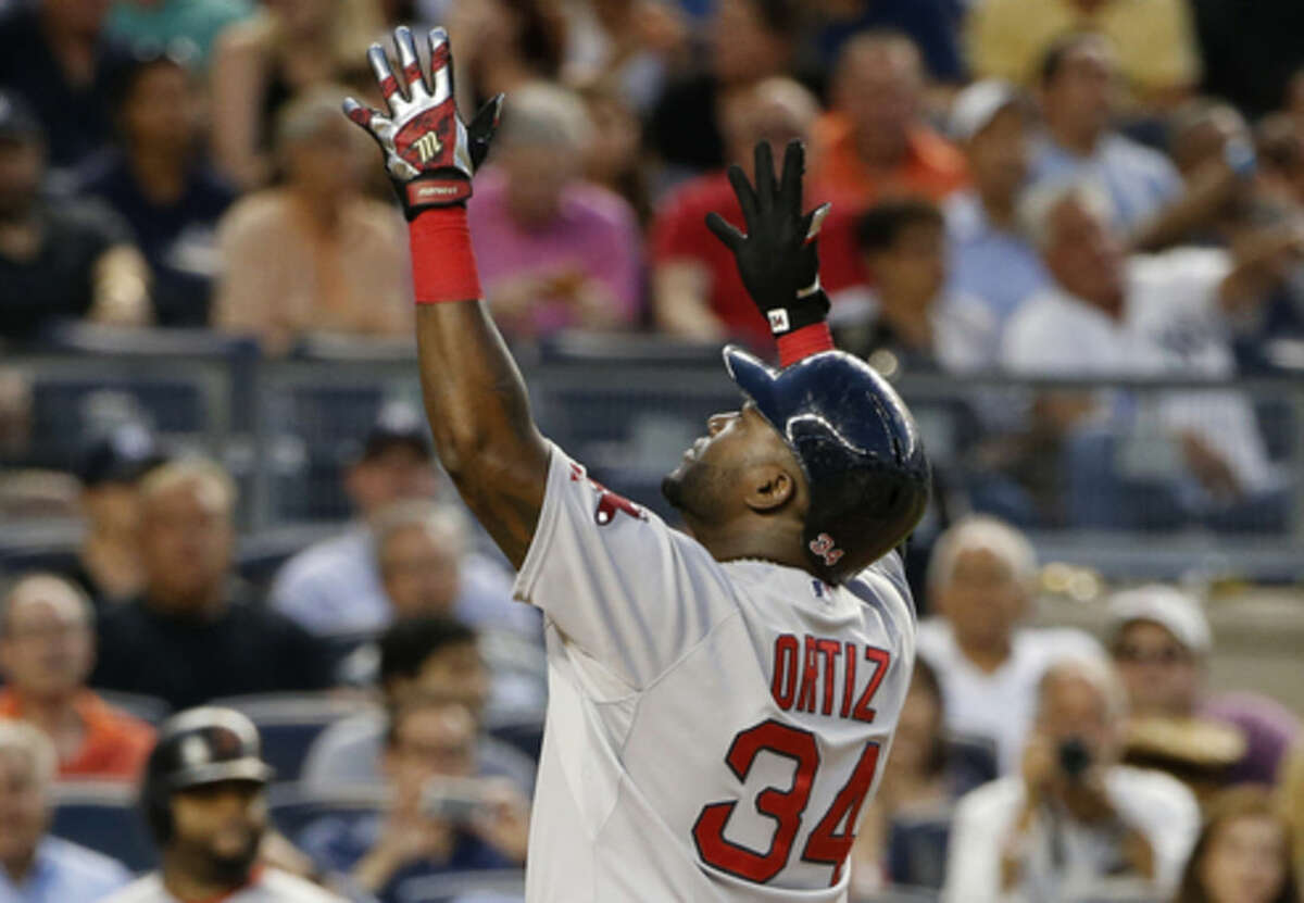 Boston Red Sox designated hitter David Ortiz (34) reacts at the plate after hitting a solo home run off New York Yankees starting pitcher Luis Severino in the fourth inning of a baseball game at Yankee Stadium in New York, Wednesday, Aug. 5, 2015. (AP Photo/Kathy Willens)
