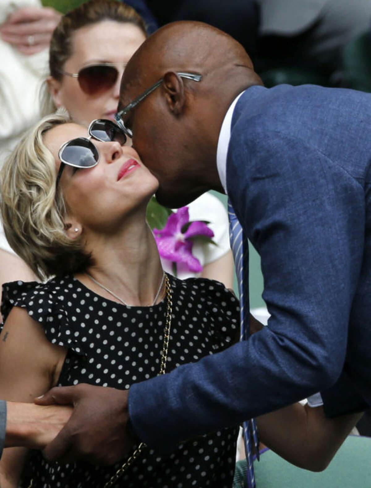 U.S actor Samuel L. Jackson, right, kisses Elsa Pataky as he arrives in the Royal Box prior to the men's singles final between Roger Federer of Switzerland and Novak Djokovic of Serbia on centre court at the All England Lawn Tennis Championships in Wimbledon, London, Sunday July 6, 2014. (AP Photo/Ben Curtis)