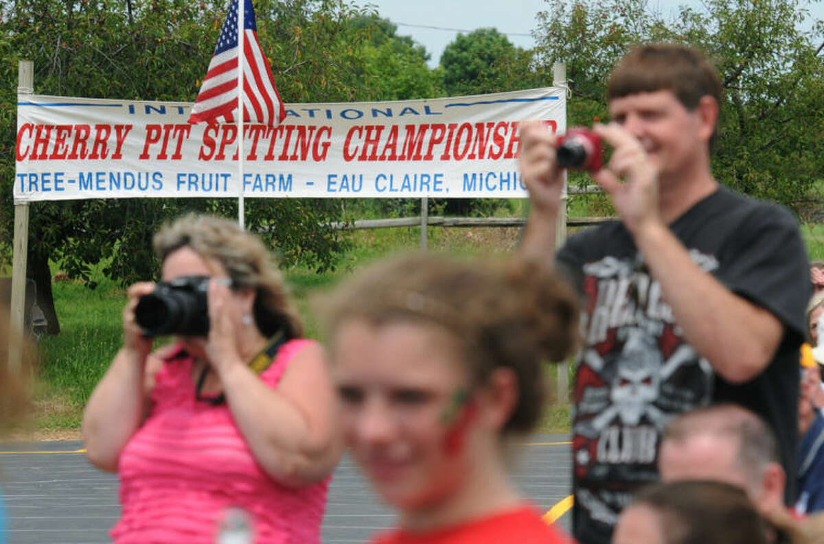 Fans watch during the 41st International Cherry Pit-Spitting Championship on Saturday, July 5, 2014, at Tree-Mendus Fruit Farm in Eau Claire, Mich. (AP Photo/The Herald-Palladium, Don Campbell)