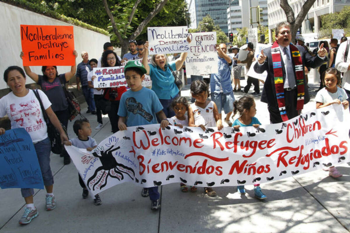 Immigrant families and children's advocates rally in response to President Barack Obama's statement on the crisis of unaccompanied children and families illegally entering the United States, outside the Los Angeles Federal building Monday, July 7, 2014. A top Obama administration official says no one, not even children trying to escape violent countries, can illegally enter the United States without eventually facing deportation proceedings. (AP Photo/ Nick Ut)