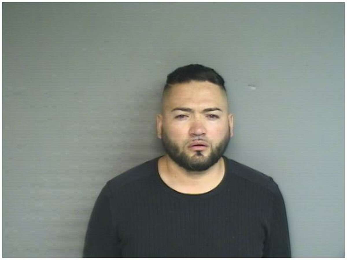 This photo provided by the Stamford Police Department shows Miguel Angel Palencia, 30, who is accused of stealing victim's credit card information to make personal purchases. 