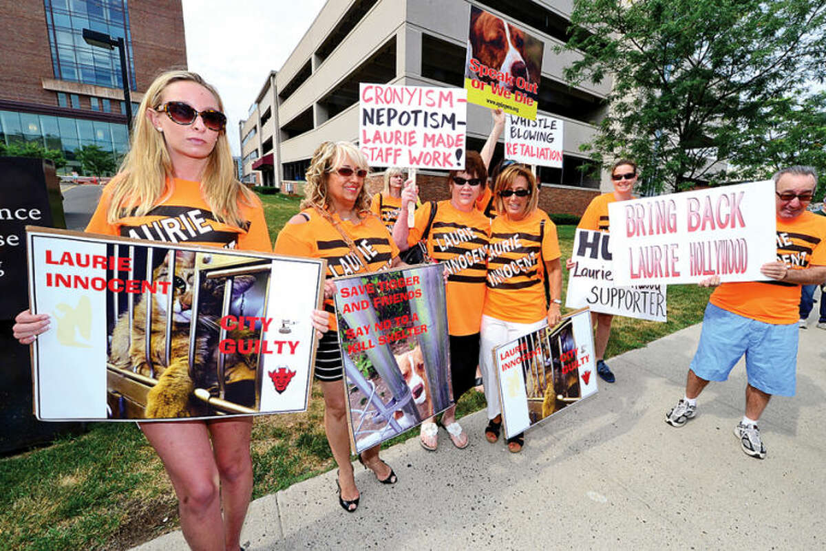 Hour photo / Erik Trautmann Supporters of former Animal Control Center manager Laurie Hollywood protest her arrest outside Stamford Superior Court Thursday morning.