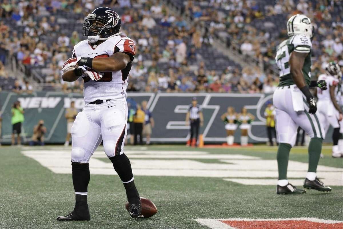Atlanta Falcons running back Terron Ward (33) celebrates after rushing for a touchdown as New York Jets' David Harris (52) walks away during the first half of a preseason NFL football game Friday, Aug. 21, 2015, in East Rutherford, N.J. (AP Photo/Adam Hunger)