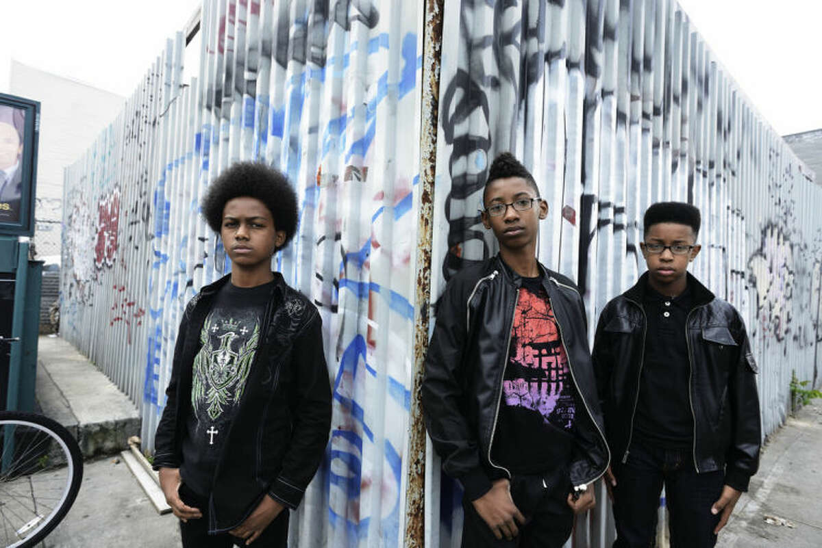 This image released by Penguin Young Readers Group shows, from left, Malcolm Brickhouse, Alec Atkins and Jarad Dawkins of the teen metal band Unlocking the Truth. The band recently signed a multi-album deal with Sony and plans to release a book next year. The book written by the Brooklyn trio, will chronicle the group's "path to success." Unlocking the Truth is signed to the new label The Cherry Party, a division of Sony. (AP Photo/Penguin Young Readers Group, Phil Knott)