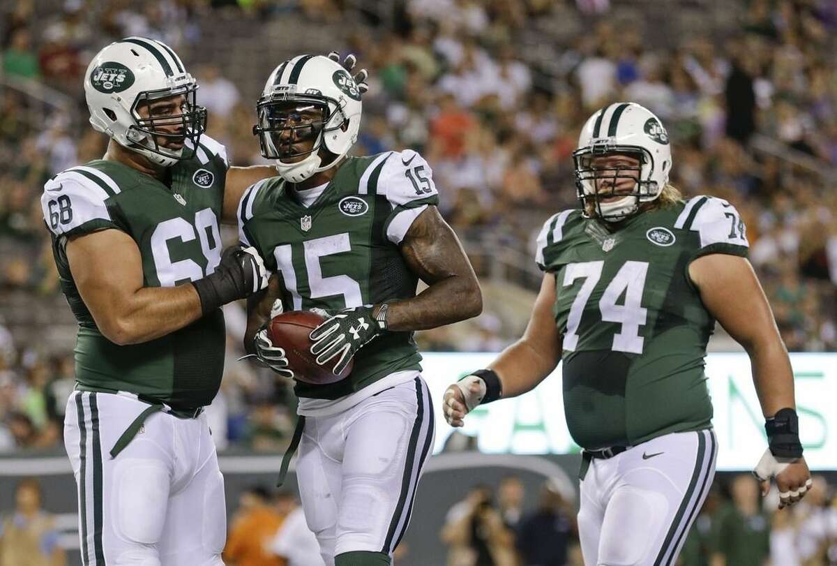 New York Jets' Breno Giacomini (68) and Nick Mangold (74) celebrate with Brandon Marshall (15) after Marshall's catch for a two point conversion during the first half of a preseason NFL football game against the Atlanta Falcons Friday, Aug. 21, 2015, in East Rutherford, N.J. (AP Photo/Adam Hunger)