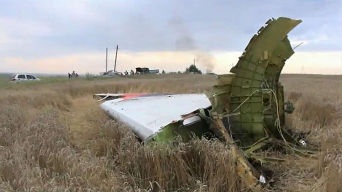 In this image taken from video, Thursday July 17, 2014, showing part of the wreckage of a passenger plane carrying 295 people was shot down Thursday as it flew over the country and plumes of black smoke rose up near a rebel-held village Hrabove, in eastern Ukraine. Malaysia Airlines tweeted that it lost contact with one of its flights as it was traveling from Amsterdam to Kuala Lumpur over Ukrainian airspace. (AP Photo / Channel 1) RUSSIA OUT - TV OUT