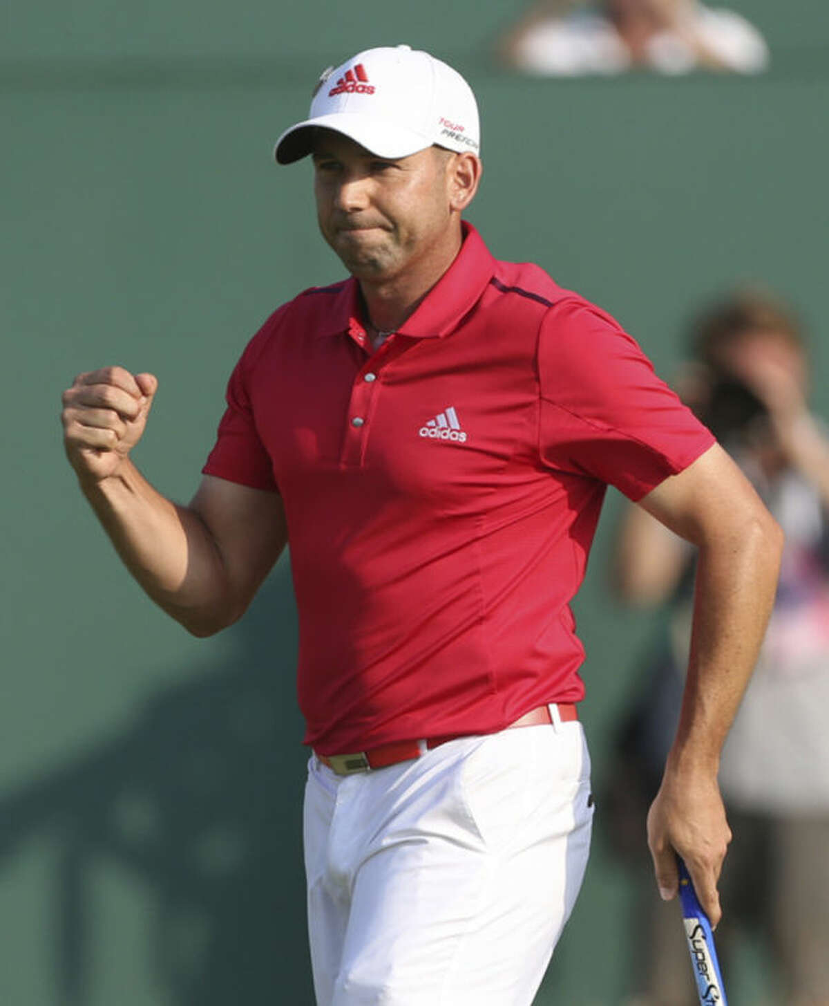 Sergio Garcia of Spain celebrates on the 18th green after finishing his round on the second day of the British Open Golf championship at the Royal Liverpool golf club, Hoylake, England, Friday July 18, 2014. (AP Photo/Peter Morrison)
