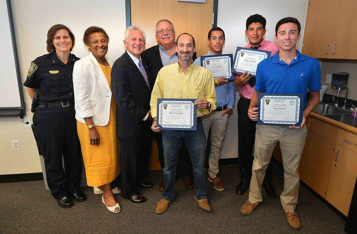 Hour Photo/Alex von Kleydorff L-R Deputy Chief Susan Zecca, Police Commissioner Fran Collier-Clemmons, and Mayor Harry Rilling, Commissioner Charles Yost present father Alvaro Gonzalez, lifeguards Juan Gonzalez, Calos Aspiazu and Nico Osorio with certificates for their efforts in chasing and catching a thief who stole a purse at Calf Pasture beach.