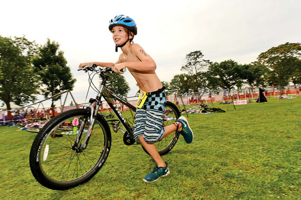 Hour photo / Erik Trautmann Thomas Shehadeh competes in the 11-14 year old division of the 2014 Mini Mossman Youth Triathlon at Calf Pasture Beach Saturday.