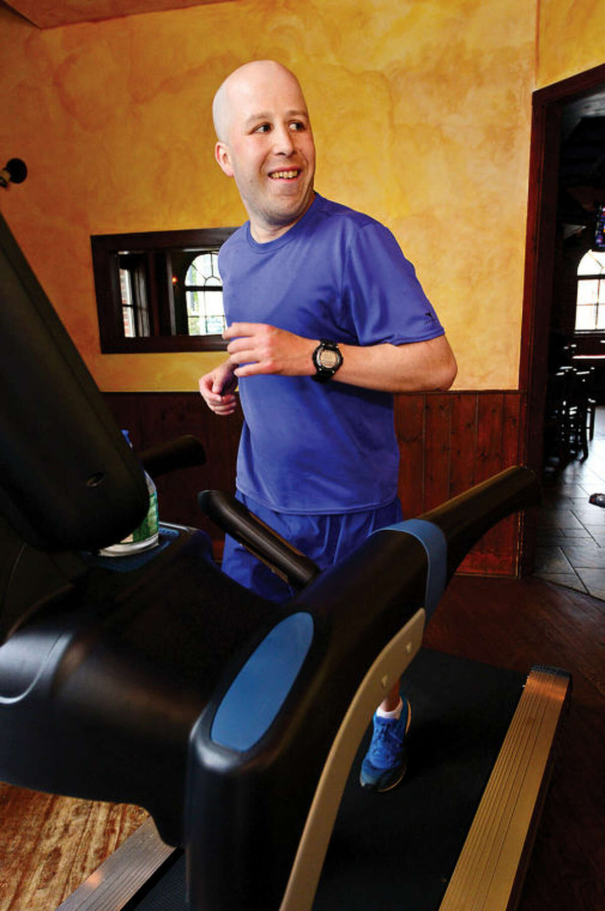 Norwalk resident Jimmy Booth participates in the “Run in the Pub” charity event at O’Neill’s Pub saturday. Booth runs the marthon on a treadmill to benefit the Open Door Shelter and Jo Mazzo’s Time to Fight fund.