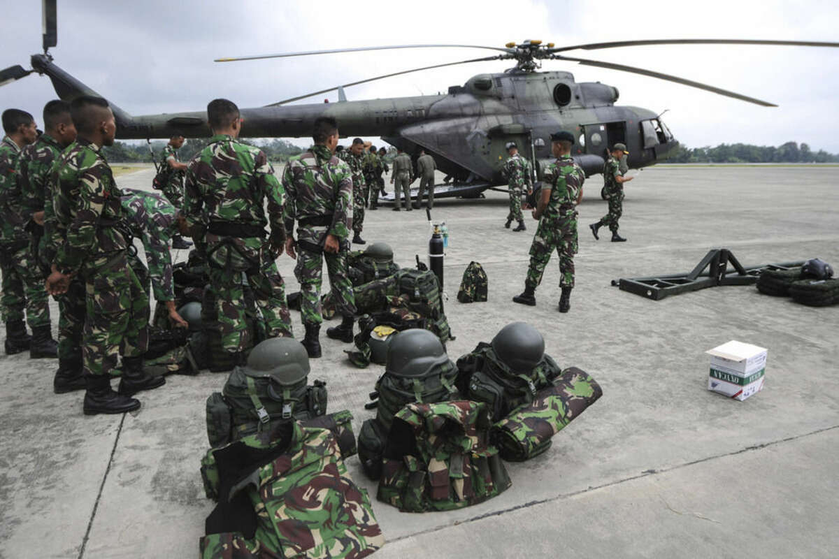 In this photo released by China's Xinhua News Agency, soldiers prepare to leave for the crash site of an Indonesian passenger plane for rescue operations at an air base in Jayapura, Indonesia Tuesday, Aug. 18, 2015. The Indonesian passenger plane that went missing two days ago was destroyed when it slammed into a mountain, killing all people on board, the country's top rescue official said. (Veri Sanovri/Xinhua via AP) NO SALES