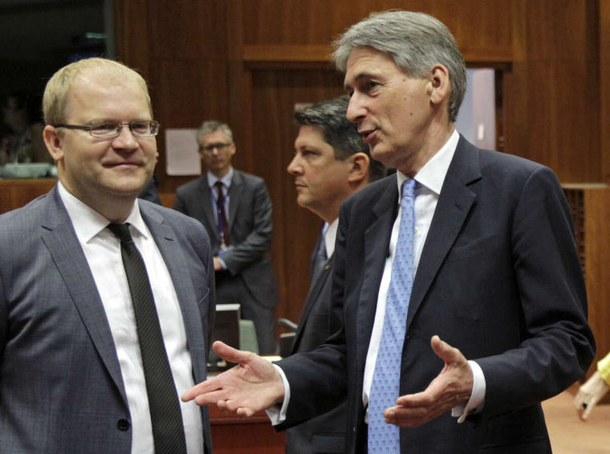 British Foreign Secretary Philip Hammond, right, talks with Estonia's Foreign Minister Urmas Paet during an EU foreign ministers council at the European Council building in Brussels, Tuesday, July 22, 2014. European Union foreign ministers are meeting to consider further sanctions against Russia because of the downing of a Malaysian jetliner, with Britain and some other countries demanding much tougher measures. (AP Photo/Yves Logghe)
