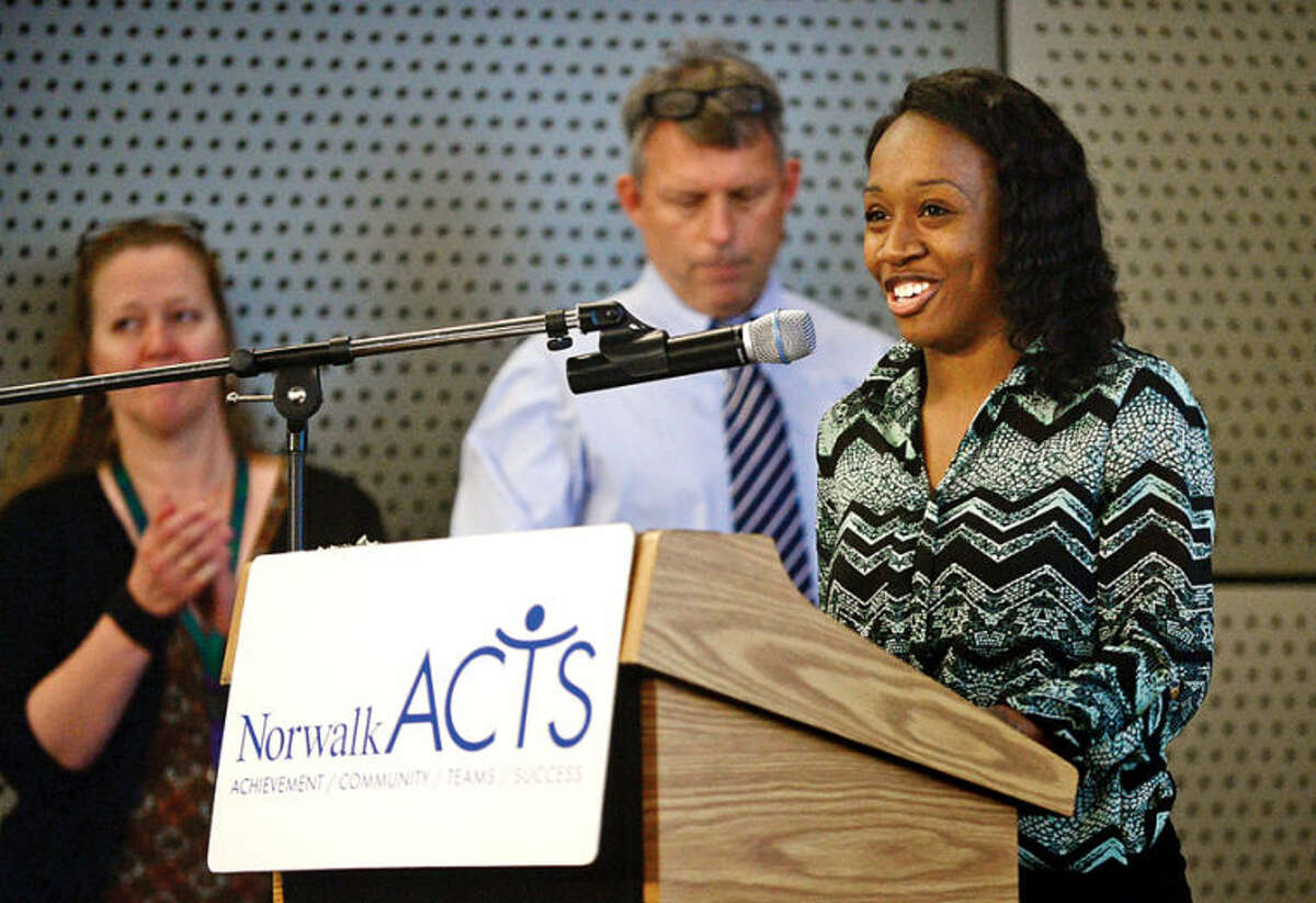 Hour photo / Erik Trautmann "I Have a Dream" scholar Jasmine Pressie reads the opening of the “Memorandum of Understanding” before Norwalk ACTS members sign a the agreement to ensure a coordinated and integrated coalition of resources to dramatically improve educational, social and emotional growth and physical health outcomes for Norwalk's children during a press event follwing ACTS monthly meeting.