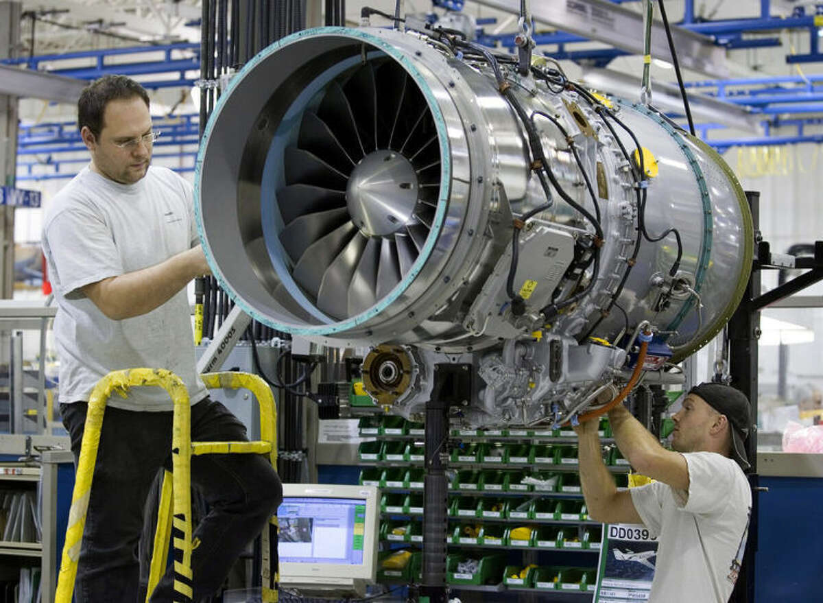 FILE -- In this Dec. 13, 2006 file photo, workers assemble a PW500 engine destined for a Cesna Citation at the Pratt & Whitney plant in Longueuil, Quebec, Canada. Sale of private jets, like the Citation, are rising again in 2014 after the deep recession when the company plane was an easy target for spending cuts. Pratt & Whitney Canada laid off more than 400 workers in 2009 and 2010. But company president Paul Adams said in May 2014 that improvements in the top part of the business have driven the market?•s recovery, (AP Photo/The Canadian Press, Paul Chiasson, File)
