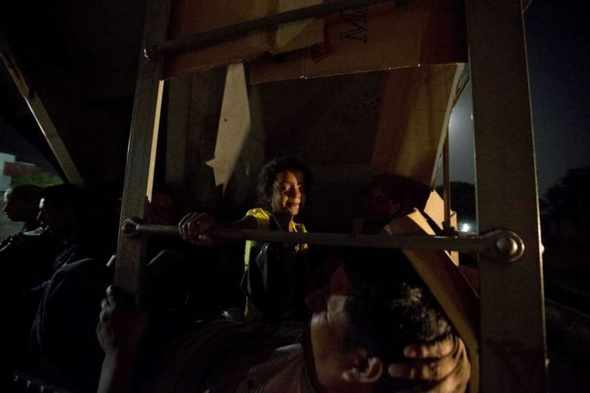In this July 11, 2014, photo, Central American migrants ride a freight train during their journey toward the U.S.-Mexico border in Chahuites, Mexico. Many children and teenagers who travelled to the United States recently said they did so after hearing they would be allowed to stay. (AP Photo/Eduardo Verdugo)
