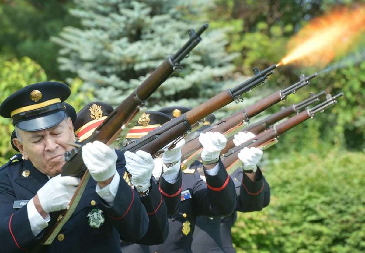 Hour Photo/Alex von Kleydorff The 1st Company Governors Footguard fires a 21 gun salute to start the 5th Annual Housing For Heroes Connecticut Golf Classic at Shorehaven Country Club on Monday.