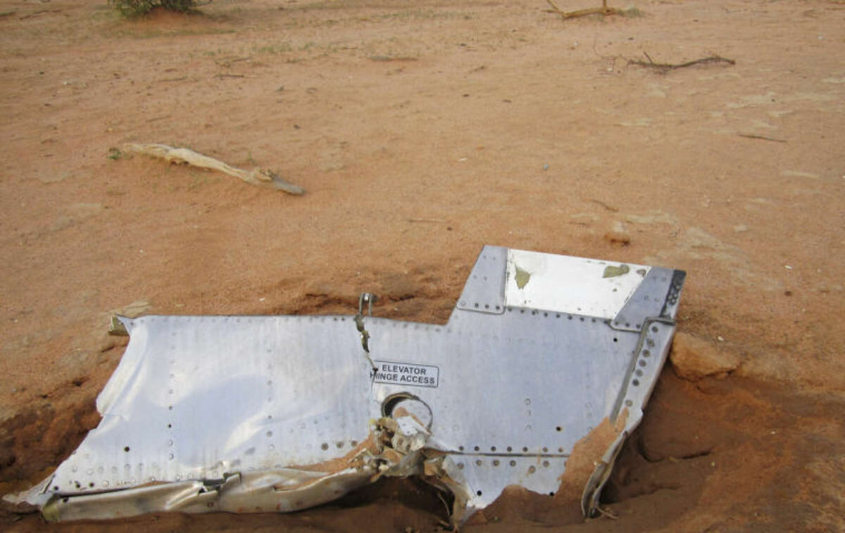 This photo provided on Friday, July 25, 2014, by the Burkina Faso Military shows a part of the plane at the crash site, in Mali. French soldiers secured a black box from the Air Algerie wreckage site in a desolate region of restive northern Mali on Friday, the French president said. Terrorism hasn't been ruled out as a cause, although officials say the most likely reason for the catastrophe that killed all onboard is bad weather. At least 116 people were killed in Thursday's disaster, nearly half of whom were French. (AP Photo/Burkina Faso Military)