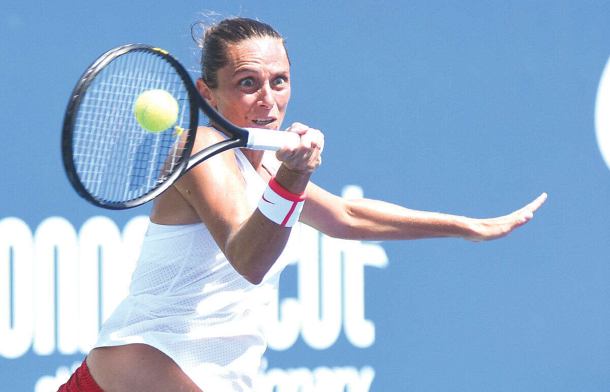 Hour photo/John Nash - Italy's Roberta Vinci puts some intensity into this forehand during her straight sets victory over Canada's Eugenie Bouchard in the first round of the Connecticut Open on Monday afternoon.