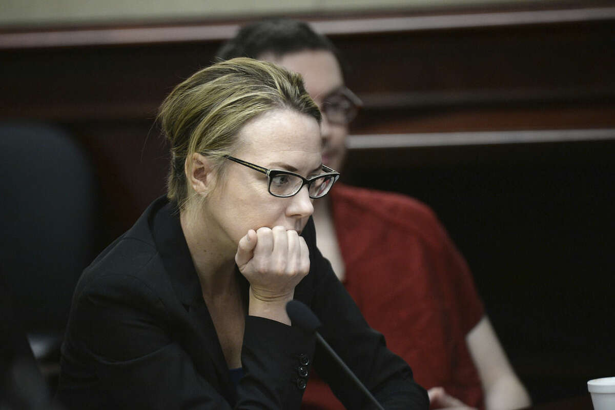 Defense Attorney Katherine Spengler, front, sits in court with James Holmes for the sentencing phase in his trial, Monday, Aug. 24, 2015, at Arapahoe County District Court in Centennial, Colo. Victims and their families were given the opportunity to speak about the shooting and its effects on their lives. Holmes was convicted Aug. 7 of murdering 12 people when he opened fire on a crowded movie theater in 2012. (RJ Sangosti/The Denver Post via AP, Pool)