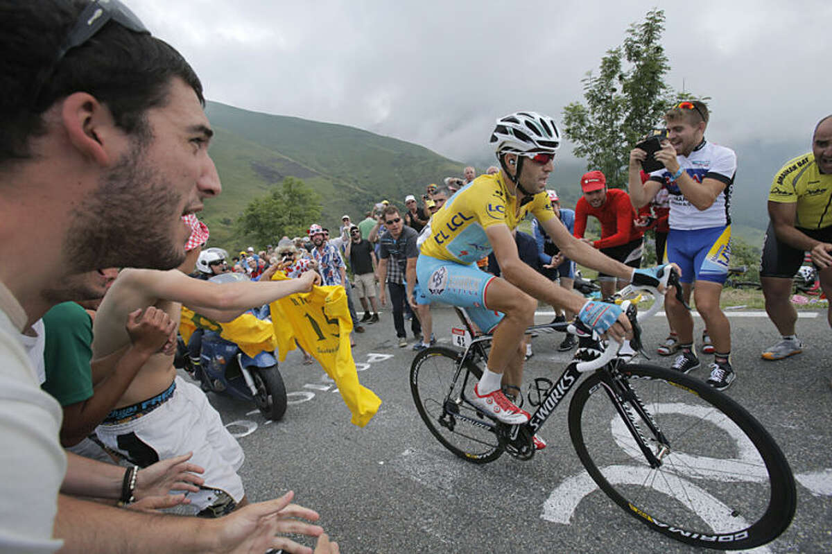 Stage winner Vincenzo Nibali of Italy climbs towards Hautacam after breaking away from his rivals during the eighteenth stage of the Tour de France cycling race over 145.5 kilometers (90.4 miles) with start in Pau and finish in Hautacam, Pyrenees region, France, Thursday, July 24, 2014. (AP Photo/Christophe Ena)