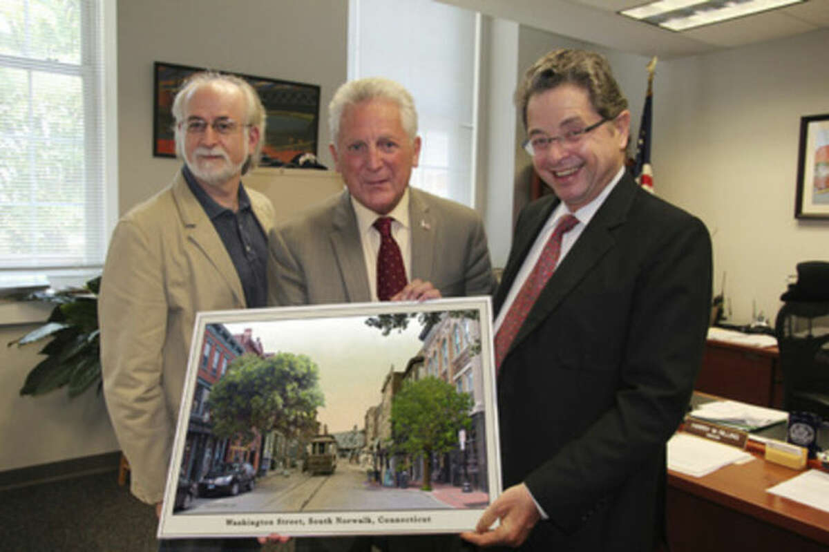 Contributed photo Norwalk Mayor Harry Rilling (center), Jeff Price and Aleks Rotner pose with artwork that was donated to the Mayor's office.