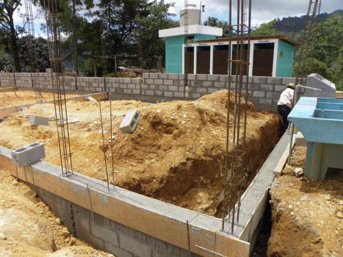 Contributed photo The supervisor for the Public Defender's Office at Norwalk Superior Court, Liz Reid, has raised funds in honor of her father to build a school in Guatemala. Pictured here is the beginning of the construction.