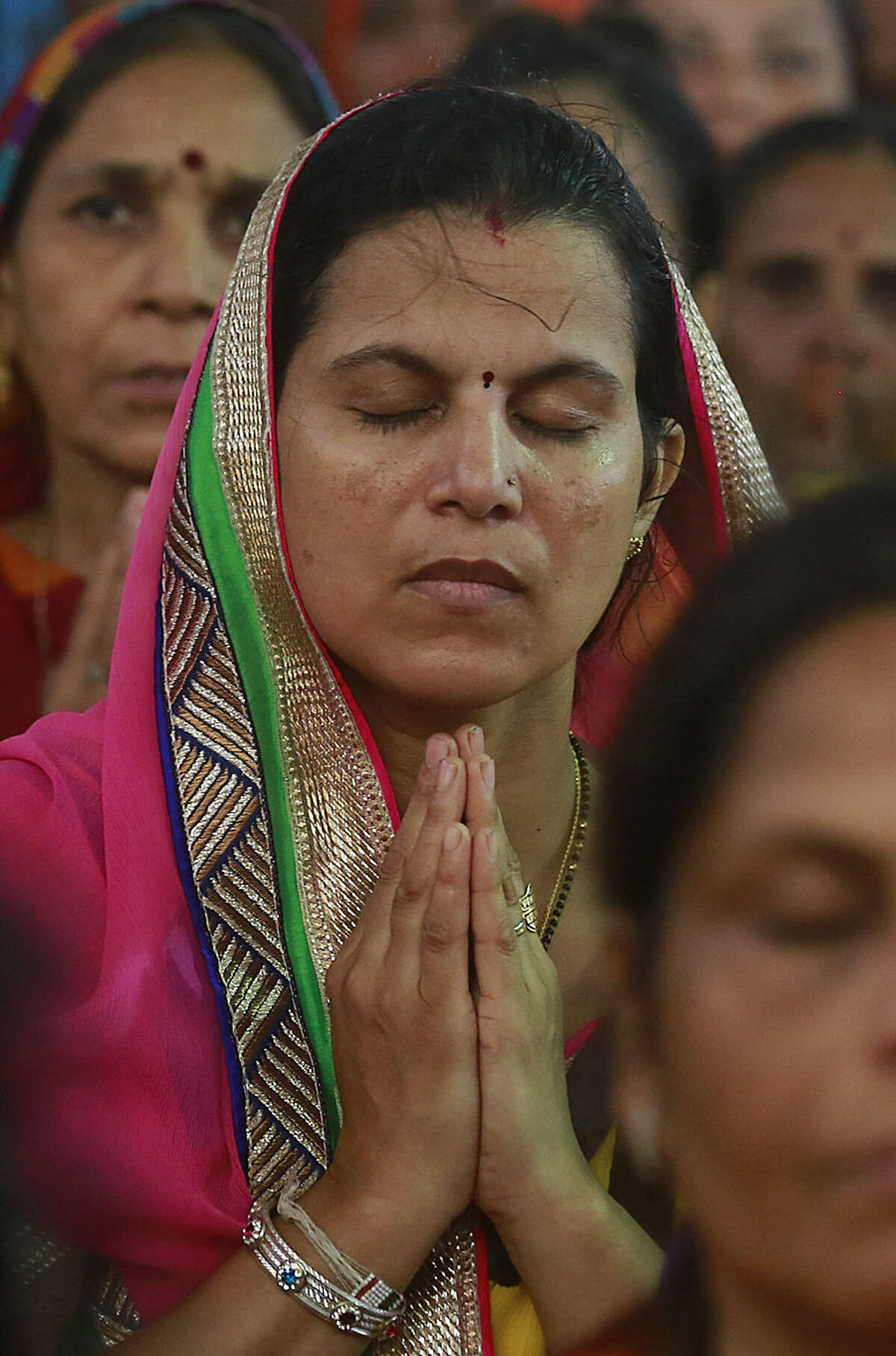 A member of India's Jain community offers prayers during a protest in Mumbai, India, Monday, Aug. 24, 2015. The Jains across India Monday protested against the recent Rajasthan High Court order banning the Jain religious ritual of Santhara, a practice of voluntarily fasting unto death. (AP Photo/Rafiq Maqbool)
