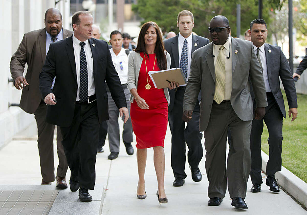 Pennsylvania Attorney General Kathleen Kane, center, departs after her preliminary hearing Monday, Aug. 24, 2015, at the Montgomery County courthouse in Norristown, Pa. Kane is accused of leaking secret grand jury information to the press, lying under oath and ordering aides to illegally snoop through computer files to keep tabs on an investigation into the leak. (AP Photo/Matt Rourke)